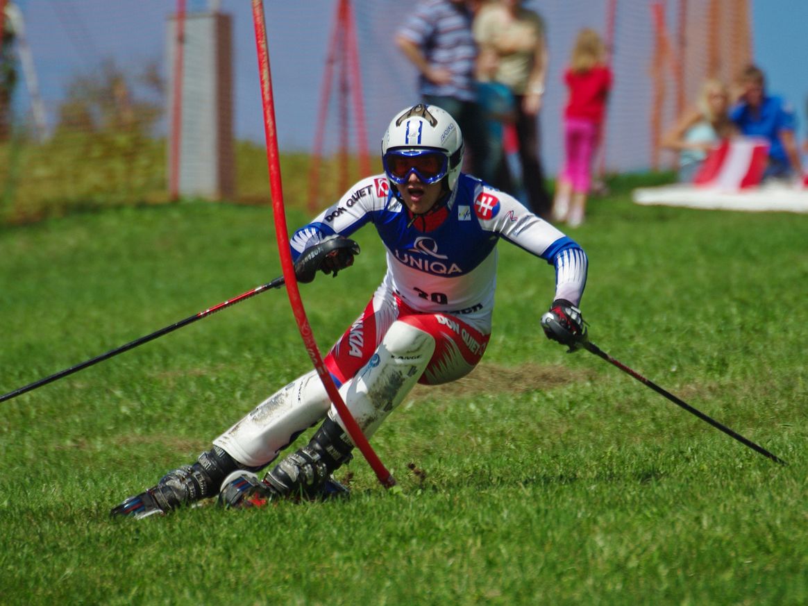 Picture of a man skiing on grass, a high-friction sport.
