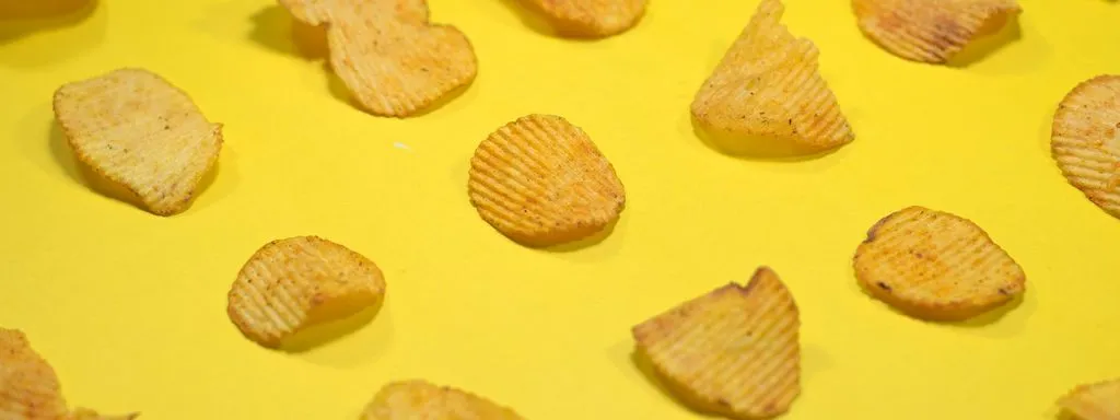 Potato chips on a yellow table